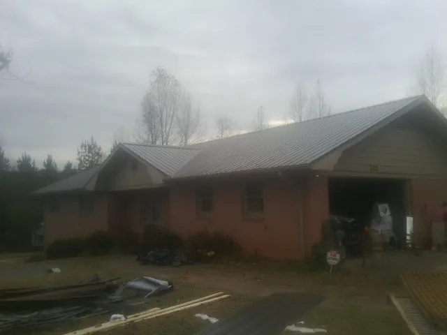 Gray metal roof on a stucco house with an attached garage in Fleetwood
